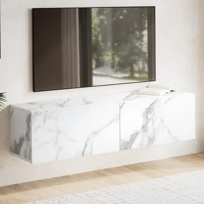 A modern, wall-mounted TV cabinet with a marble-like finish is shown mounted on a white wall, with a television above it. A book rests on top of the cabinet.