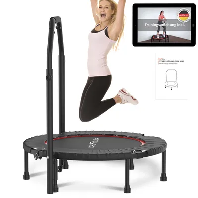 A woman is jumping on a trampoline, with a tablet and manual in the background.