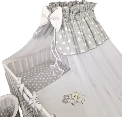 A close-up view of a baby crib with bedding and a canopy.