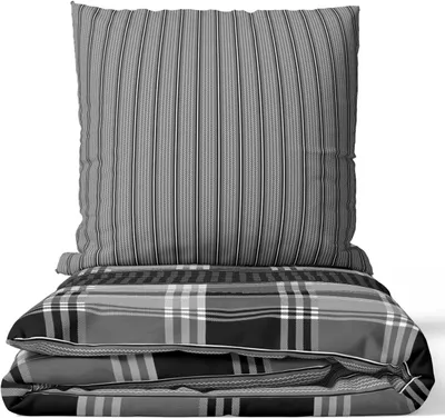 A stack of bedding, including a pillow and a duvet, against a white background.