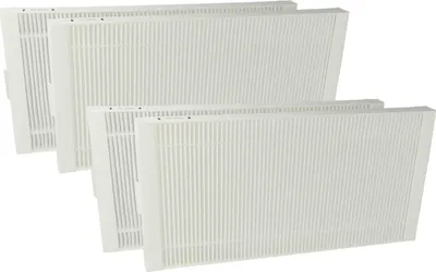 A set of four white pleated air filters, stacked diagonally.