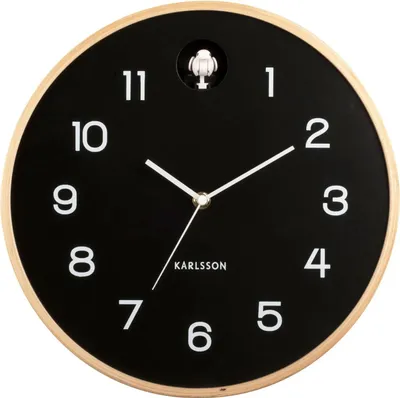 A Karlsson wall clock with a black face and white numbers, set against a plain white background.