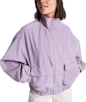 A woman wearing a purple corduroy jacket.