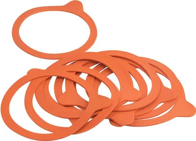 A pile of orange rubber sealing rings for canning jars.