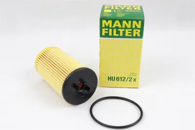 A MANN-FILTER oil filter and its packaging are displayed on a white background.