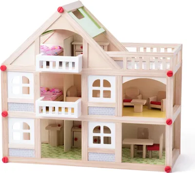 A wooden dollhouse with multiple floors and rooms, furnished with miniature furniture and bedding.
