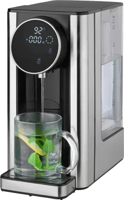 A water dispenser with a glass of tea.