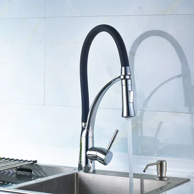 A kitchen faucet with a black hose is shown in a sink with water running.