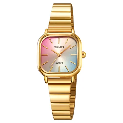 A close-up studio shot of a gold-colored women's watch with a gradient dial.