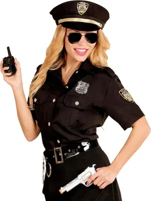 A woman dressed as a police officer, holding a toy walkie-talkie and a toy gun.