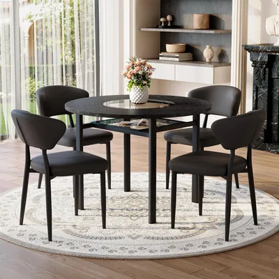 Imagen del producto de STILVORA: Juego de mesa redonda para comedor con 4 sillas fabricadas en material Polyurethany con respaldo cómodo. Mesa redonda de 100 cm con aspecto de madera negra. Juego de comedor para sala de estar, color