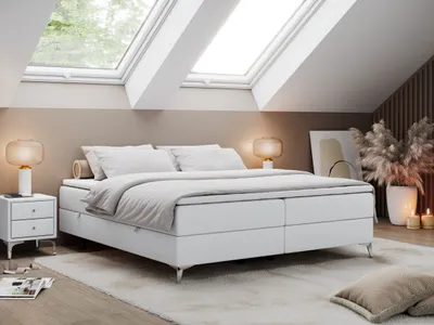 A bedroom scene with a bed, nightstand, and decorative elements.