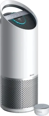 A white air purifier with a silver base and a digital display on top, shown with a small silver accessory next to it.