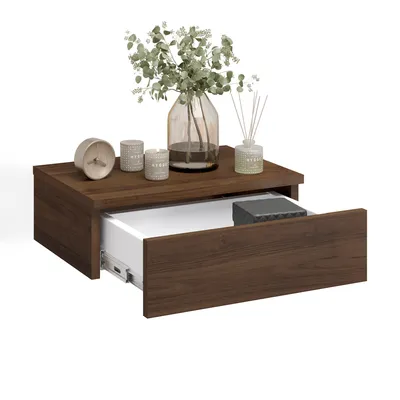 A floating nightstand with an open drawer, displaying decorative items on top.