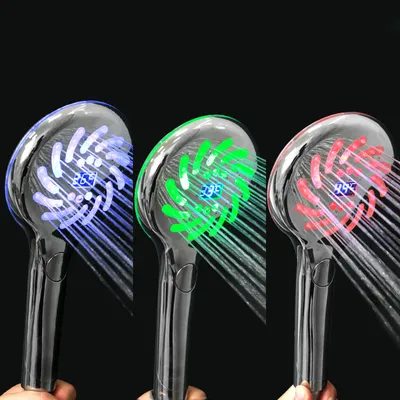 Three LED showerheads with different colored lights and water streams against a black background.