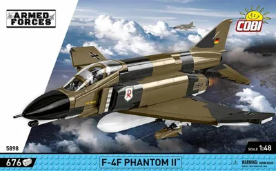 A model of a military jet in flight against a cloudy sky.