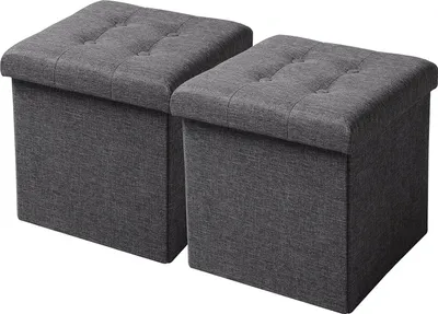 Two dark gray storage ottomans are shown side-by-side against a light gray background.
