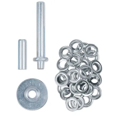 A set of metal eyelets and tools for their application, laid out on a white background.