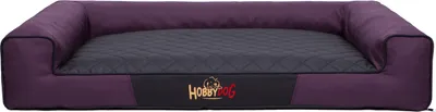 A dog bed with raised sides and a quilted center.