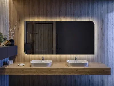 A modern bathroom vanity with two sinks and a large, illuminated mirror.