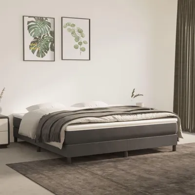 A bedroom scene with a bed and artwork on the wall.