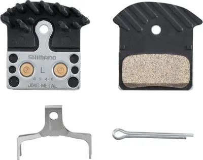 A set of bicycle brake pads and related hardware, laid out against a white background.
