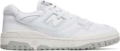A white New Balance sneaker with gray accents is shown from the side against a white background.