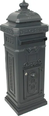A dark gray cast aluminum pillar mailbox with ornate detailing and a crown-like top.