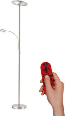 A floor lamp and a hand holding a remote control against a white background.