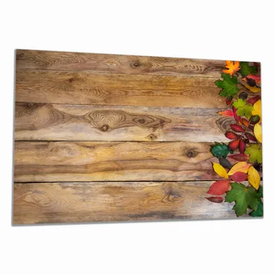 Produktbild von Wallario Herdabdeckplatte aus Glas, Größe 80 x 52 cm 1-teilig, Motiv Herbstlaub auf Holzbrettern