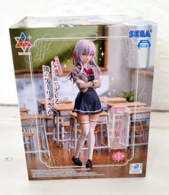 The image shows the retail packaging of an anime figure, featuring the figure itself displayed in a classroom setting.