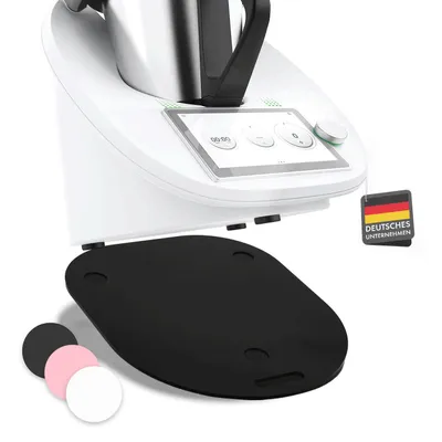 A close-up of a kitchen appliance with a mat underneath and smaller mats in the foreground.