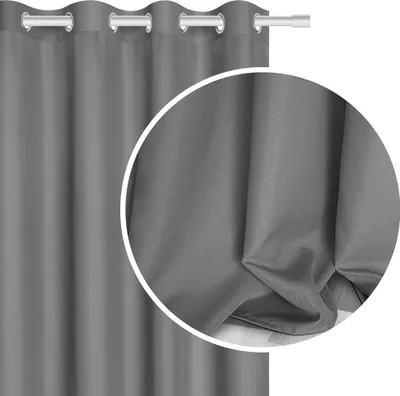 A close-up view of a gray curtain, showing its texture and folds.