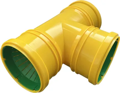 A yellow T-junction pipe fitting with green interior components, isolated on a white background.