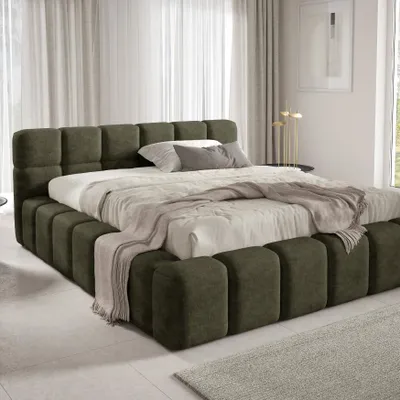 A modern bedroom with a large upholstered bed.