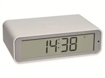 A digital alarm clock with a white casing and a gray frame around the display.