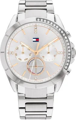 A close-up studio shot of a silver Tommy Hilfiger watch with a white dial and rose gold accents.
