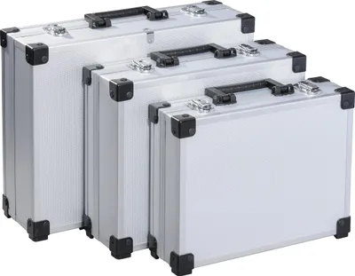 Three aluminum tool cases of different sizes are arranged diagonally.