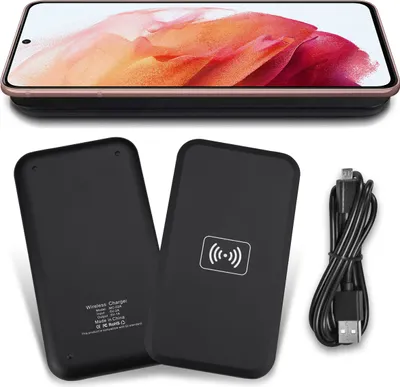 A wireless charger and cable are shown with a smartphone resting on top of the charger.