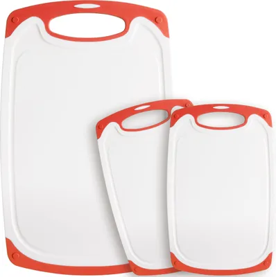 Three white cutting boards with red trim and handles are arranged in a staggered formation against a white background.