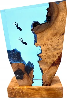A decorative sculpture of divers underwater, made from wood and epoxy resin.