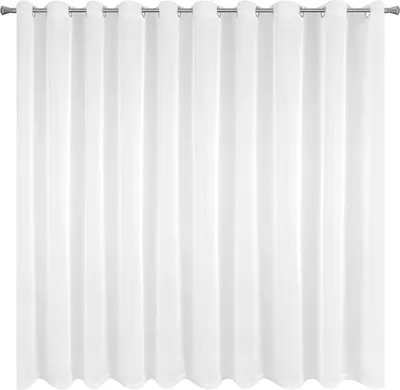 A white curtain hanging from a rod.