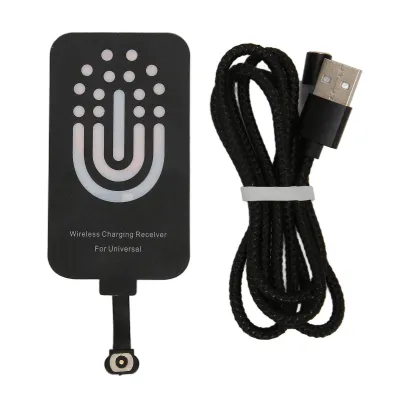 A wireless charging receiver and a USB cable are laid out on a white background.