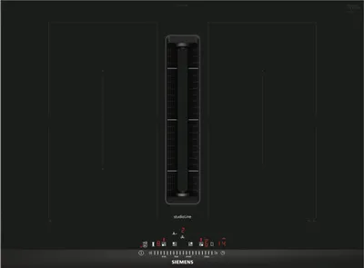 A top-down view of a black induction cooktop with an integrated downdraft ventilation system.