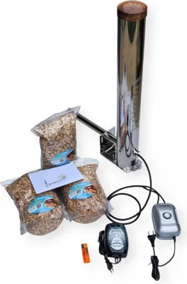 A smoking generator with bags of wood chips and accessories, displayed on a white background.