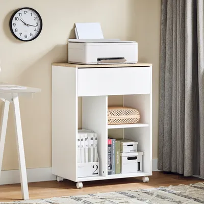 A white printer stand with a printer on top, placed in a room with a clock on the wall and curtains in the background.