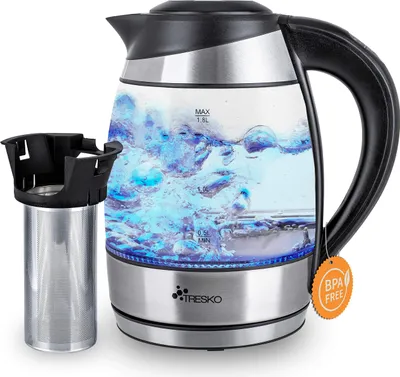 A glass electric kettle with blue LED lighting and a tea infuser next to it, set against a white background.