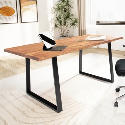 A modern office setting with a wooden desk and plants.