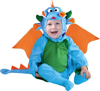 A baby wearing a dragon costume, sitting and smiling.