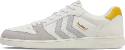 A side view of a white Hummel sneaker with gray and yellow accents.